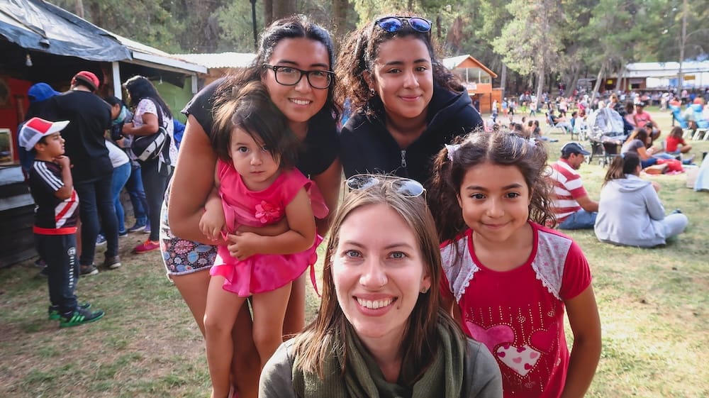 Trevelin asado festival community gathering Patagonia gaucho culture Trevelin Patagonia Fiesta Nacional del Asado Audrey Bergner with local families at a community gathering, showing how gaucho culture extends beyond ranch work into social life, festivals, and shared rural traditions in Argentina.
