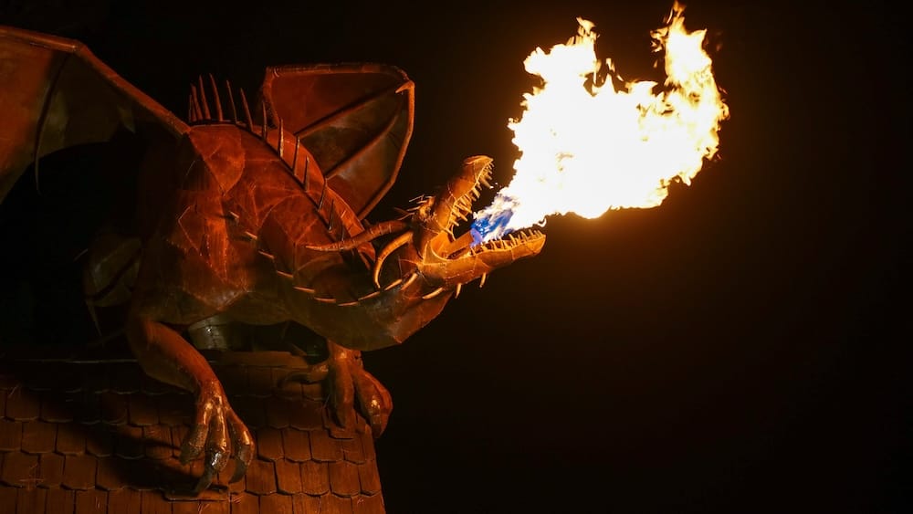 Trevelin Patagonia fire breathing dragon sculpture at night representing Welsh heritage with flames lighting up the scene highlighting one of the town’s more unique and unexpected attractions beyond its natural scenery
