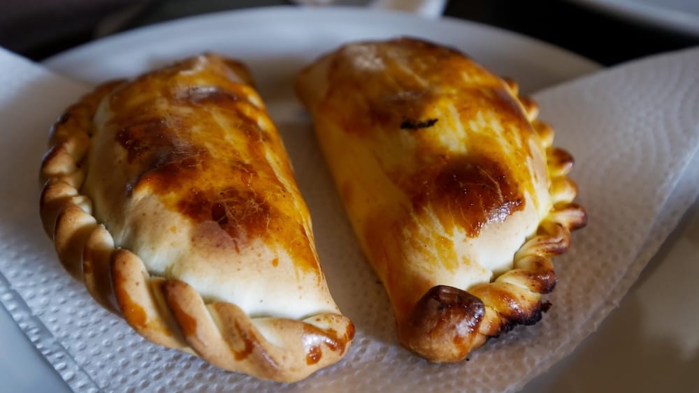 Trevelin Patagonia freshly baked empanadas on a plate with golden crust highlighting simple everyday Argentine food options available alongside restaurants and tea houses in this Andes foothills town