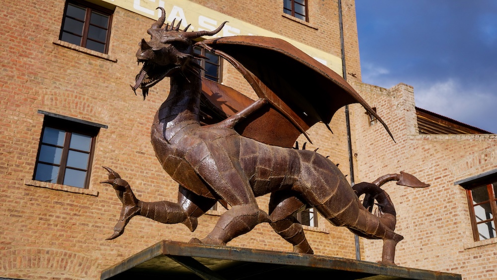 Trevelin Welsh dragon sculpture in Chubut Patagonia Argentina standing outside a brick building in the historic Welsh settlement, symbolizing the cultural heritage of Y Wladfa and the lasting legacy of Welsh immigrants in southern Argentina.