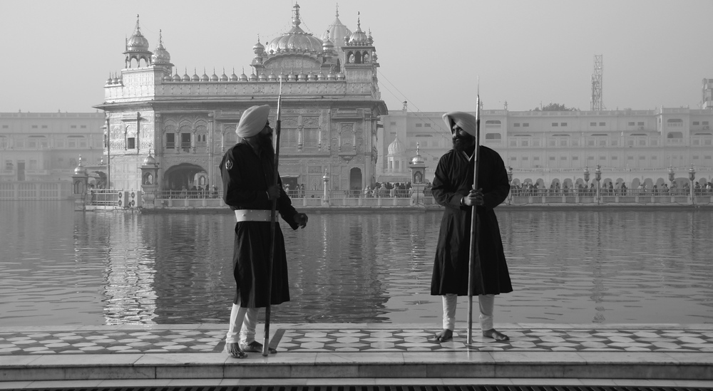 Two guards converse with one another at the Golden Temple in Amritsar, Punjab, India