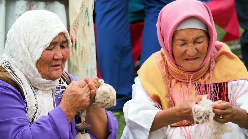 Two Kyrgyz ladies showcasing their craft during the sporting event in Kyrgyzstan