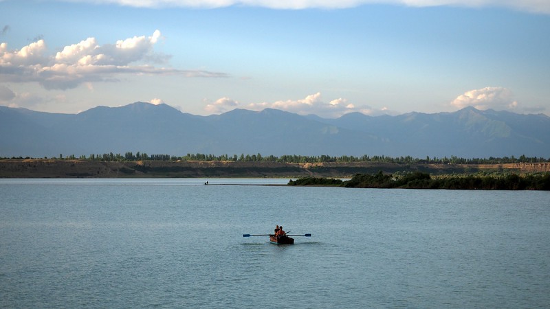 Views of a rowboat during our sunset cruise on Lake Issyk-Kul Ысык Көл Иссык Куль Przhevalsky Bay in Karakol, Kyrgyzstan