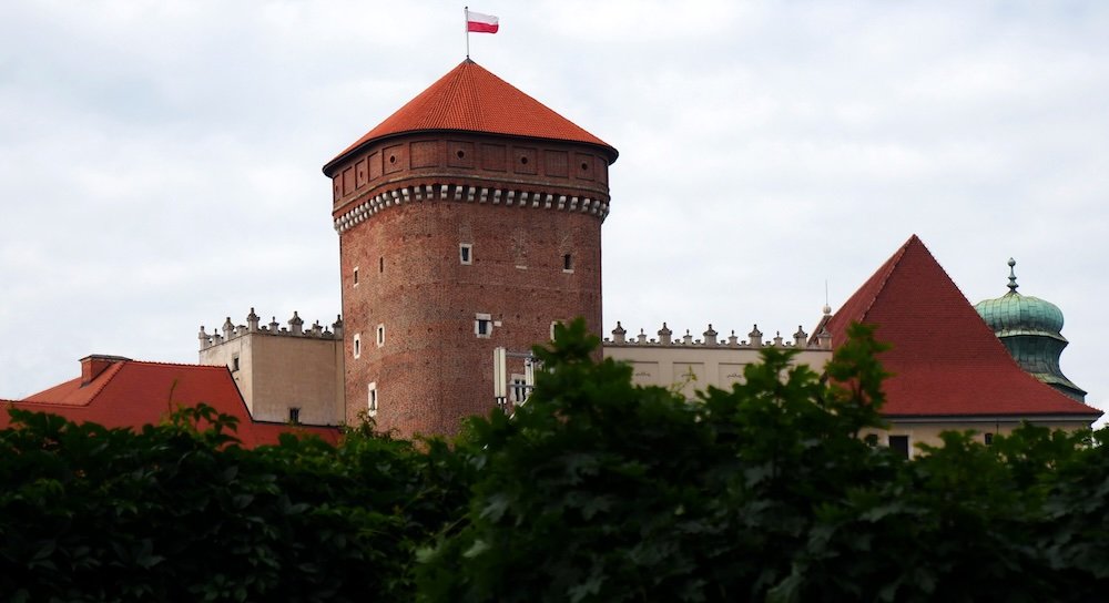 Wawel Castle Tower with Polish flag waving in Krakow, Poland