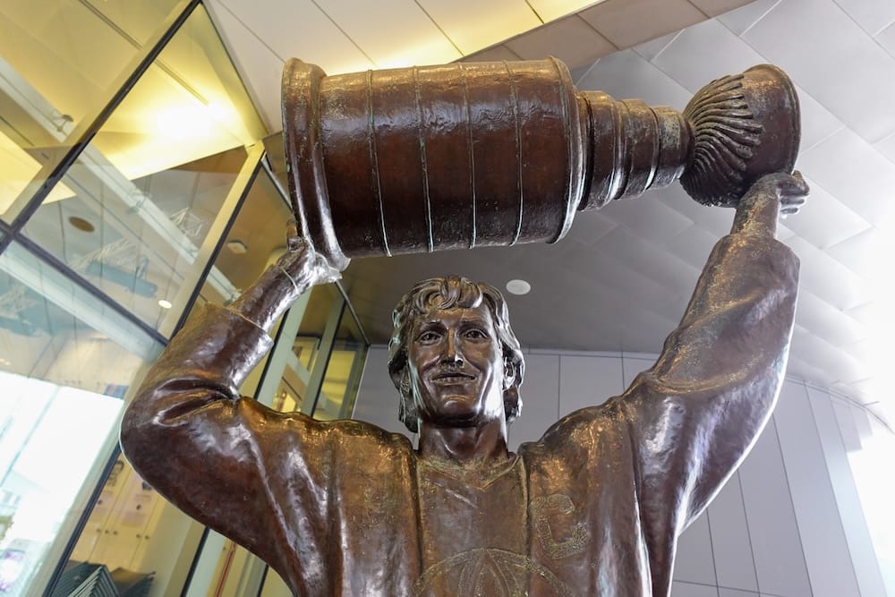 Wayne Gretzky statue with Stanley Cup, ICE District, Rogers Place, Edmonton, Alberta, Canada Bronze statue of Wayne Gretzky holding the Stanley Cup overhead, located outside Rogers Place in the ICE District, downtown Edmonton, Alberta, Canada.
