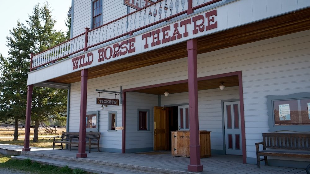 Fort Steele Heritage Town near Cranbrook, BC, featuring the historic Wild Horse Theatre with its wooden porch and ticket window, highlighting classic old-west architecture and a nostalgic stop on an easy, family-friendly day trip.