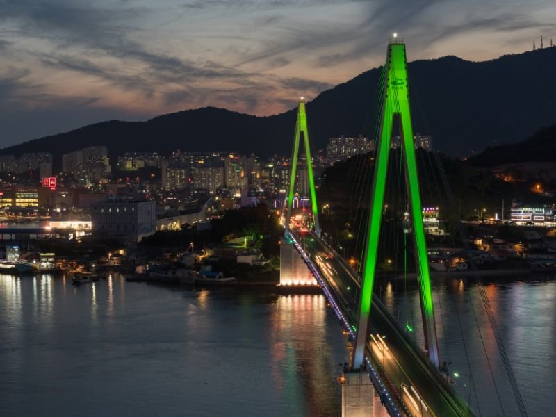 Yeosu bridge at night all lit up with views of the city