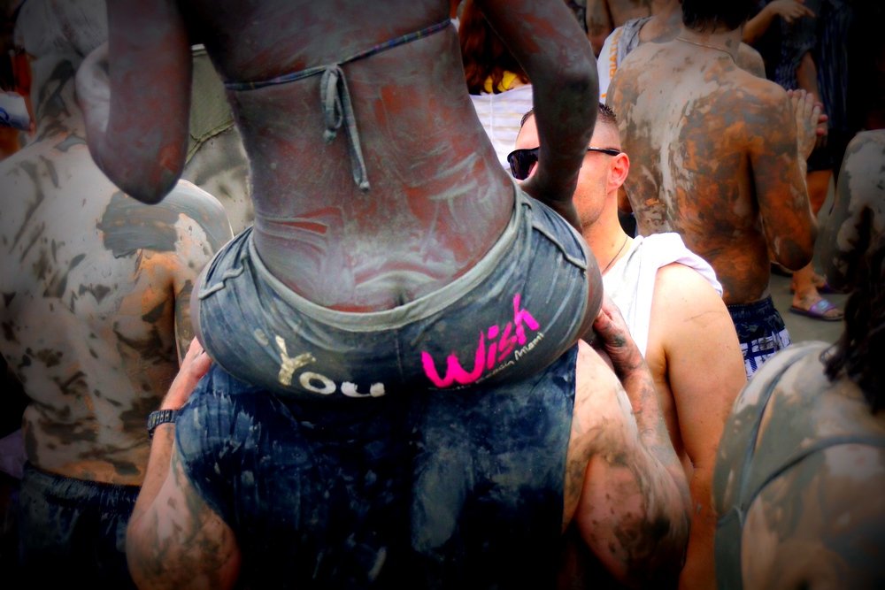 You wish shorts! A lady is being carried on piggyback through the crowd at the Boryeong Mud Festival